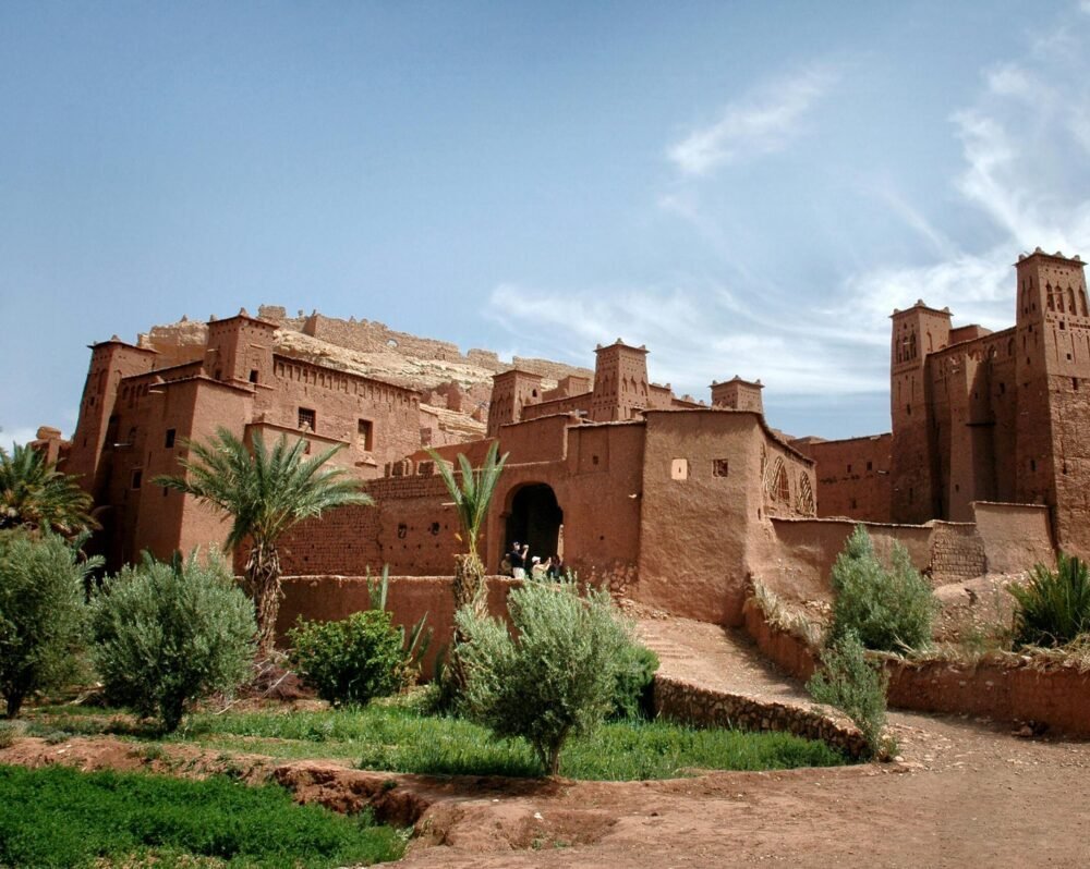 Stunning ancient clay kasbah in Ouarzazate, Morocco with clear blue sky.