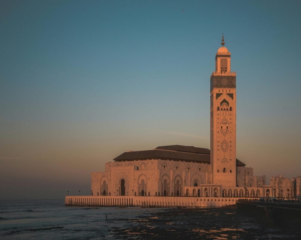 Stunning view of Hassan II Mosque against the sunset sky in Casablanca, Morocco.