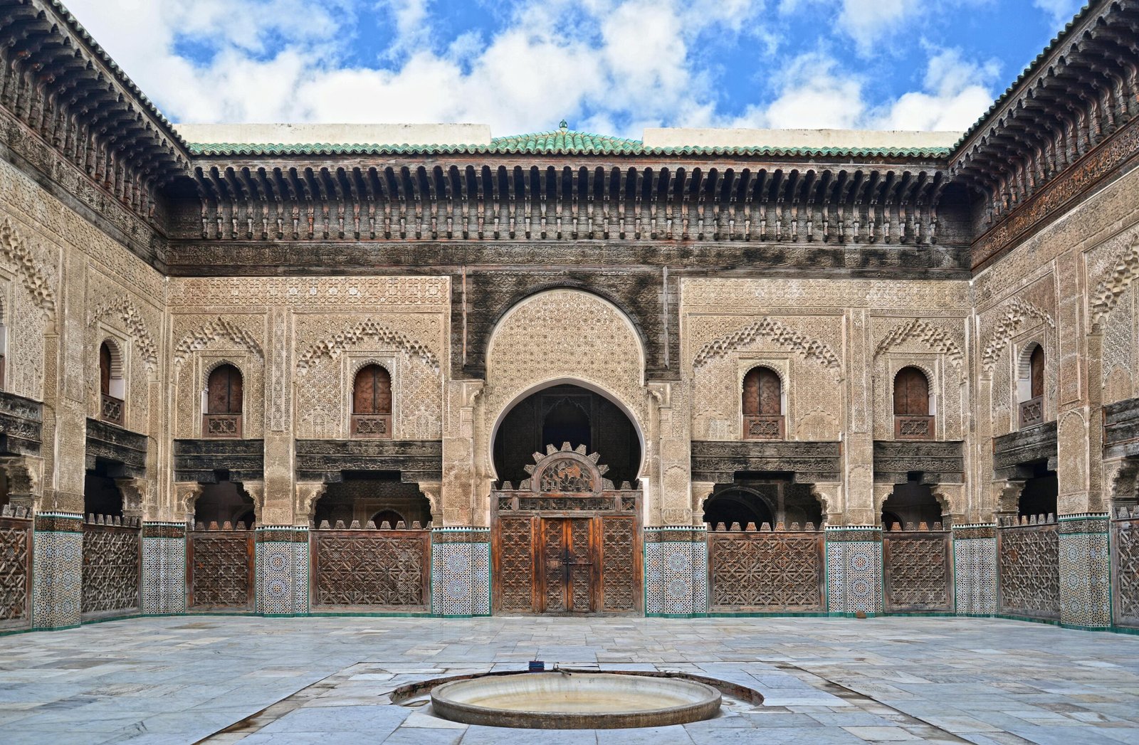 Capture of the ornate courtyard of Bou Inania Madrasa in Fès, showcasing beautiful Islamic architecture.